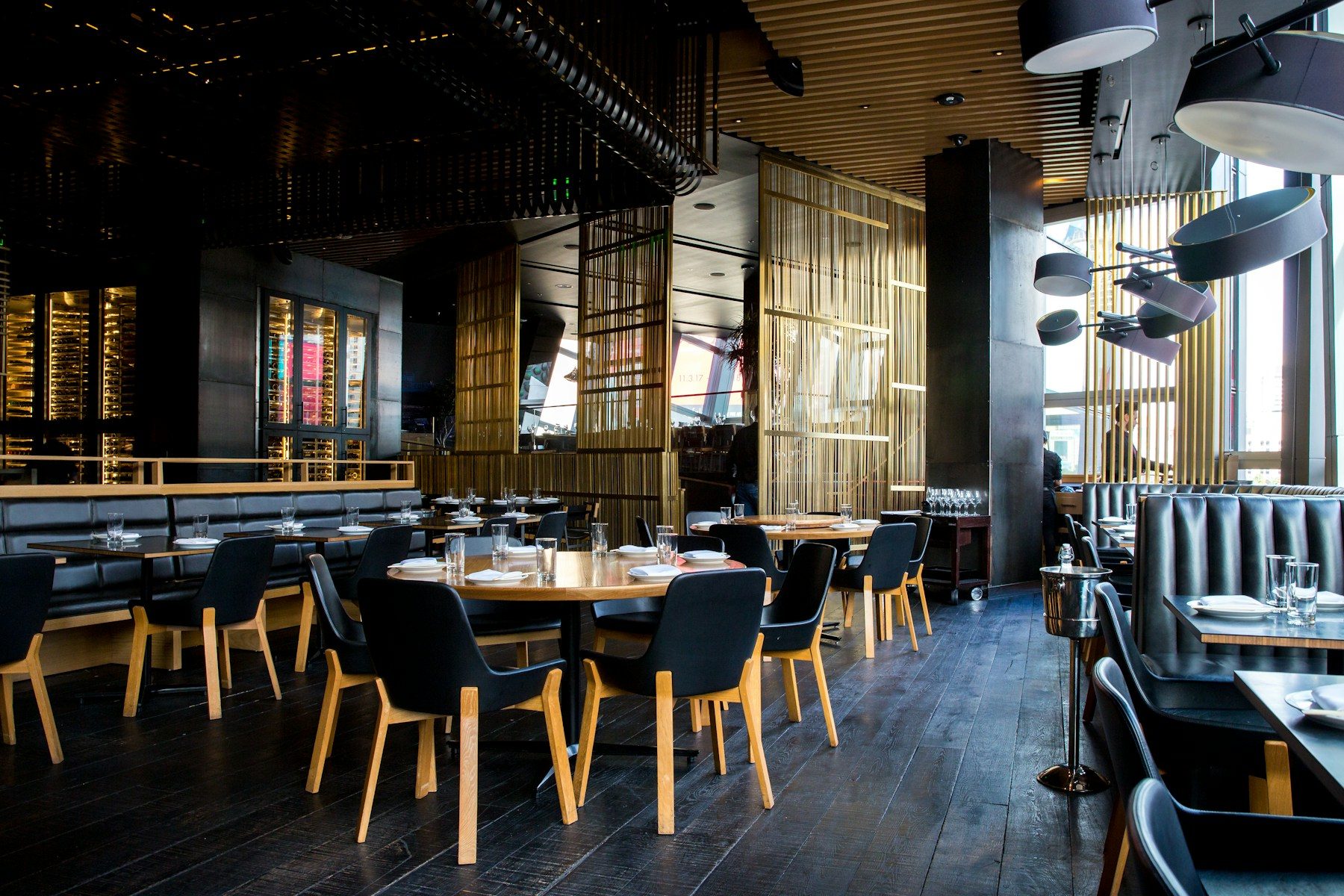 Elegant restaurant interior with wooden tables and pendant lighting